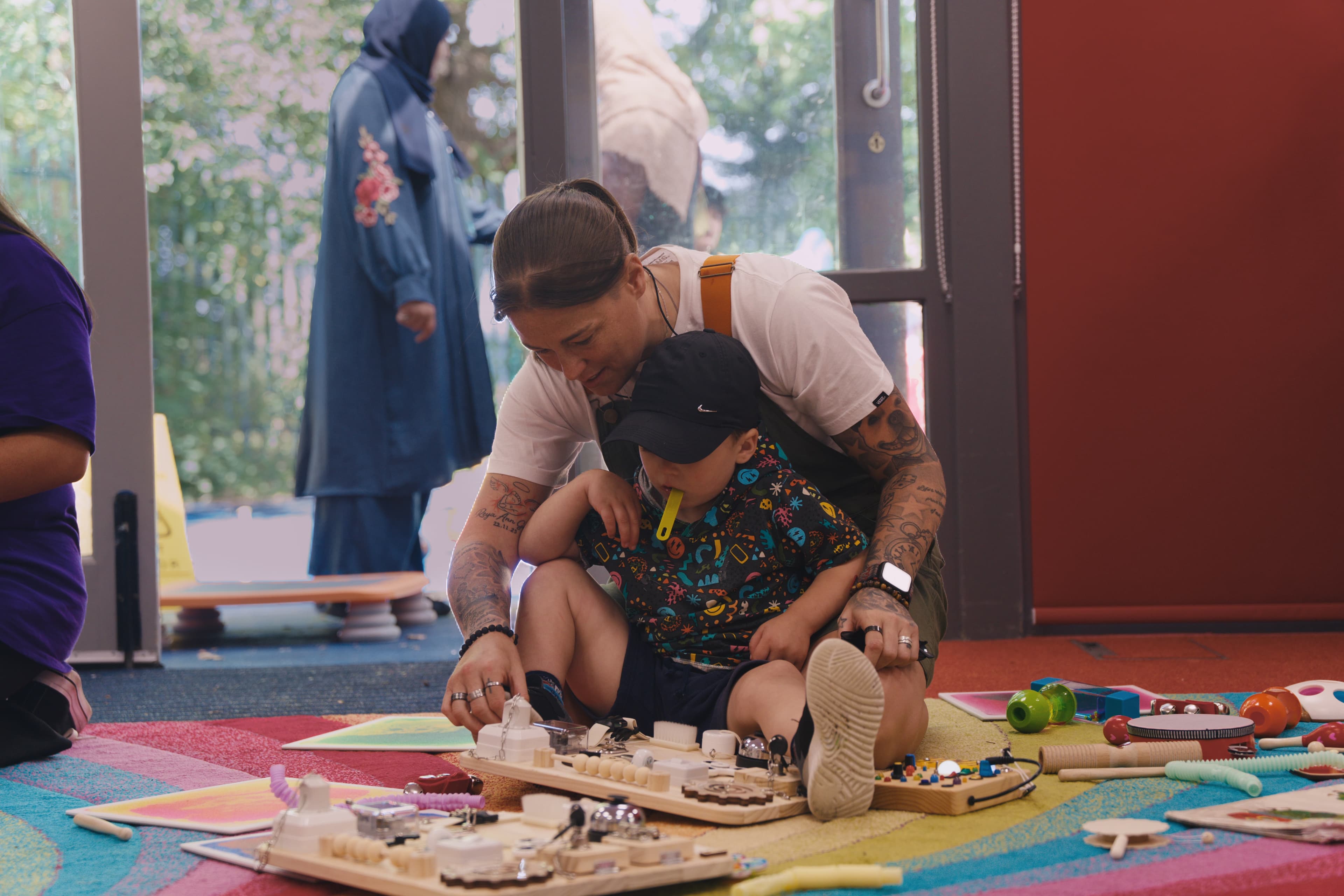 A Noa's Place team member supporting a child during sensory play